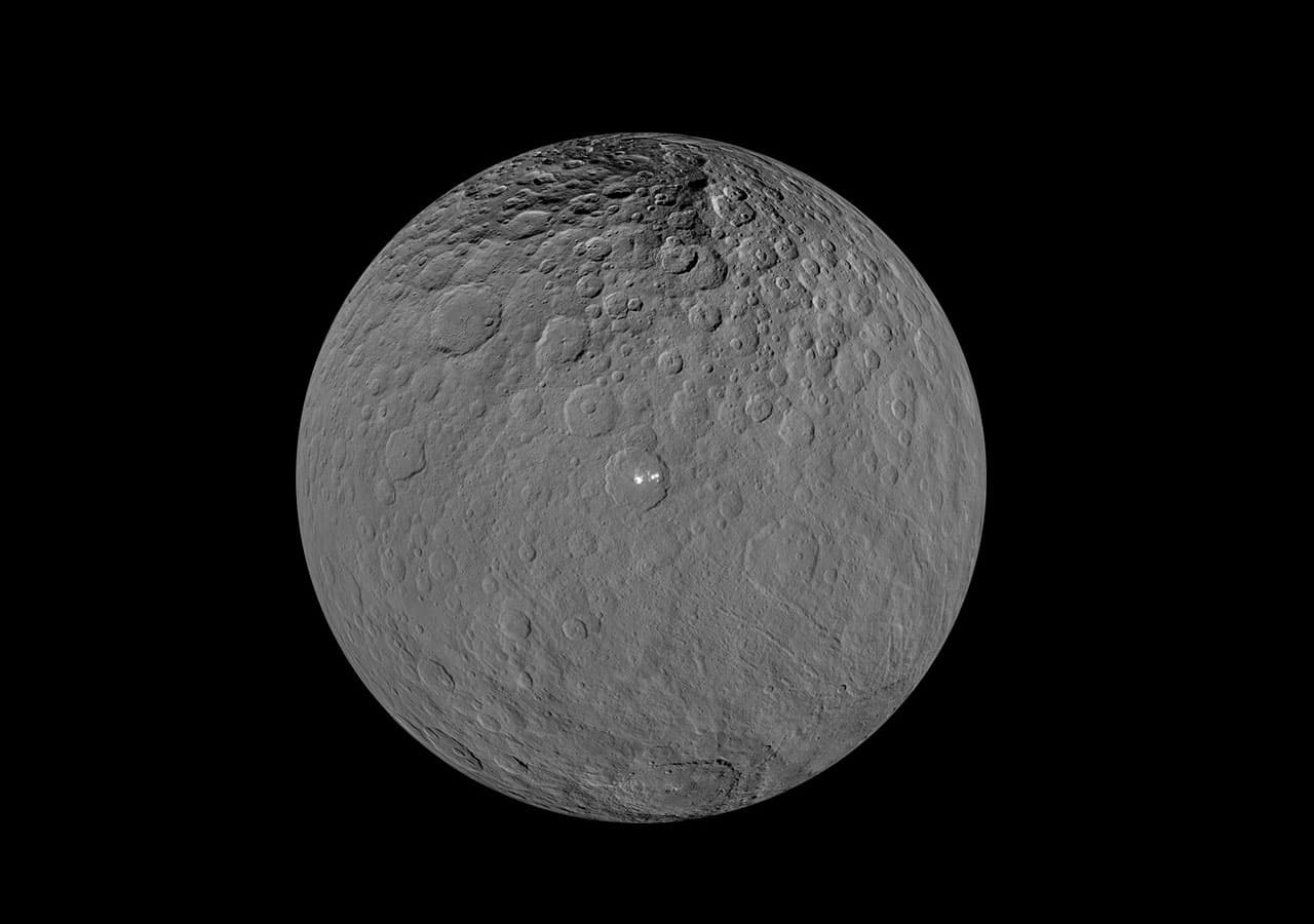 Dawn spacecraft global mosaic of Ceres with bright Occator deposits.