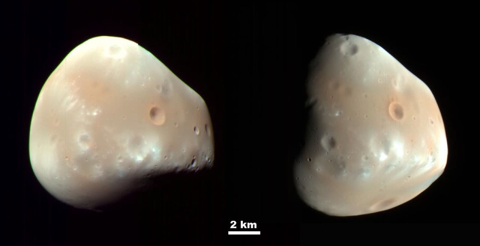 High-resolution spacecraft view of small irregular Deimos against black space.