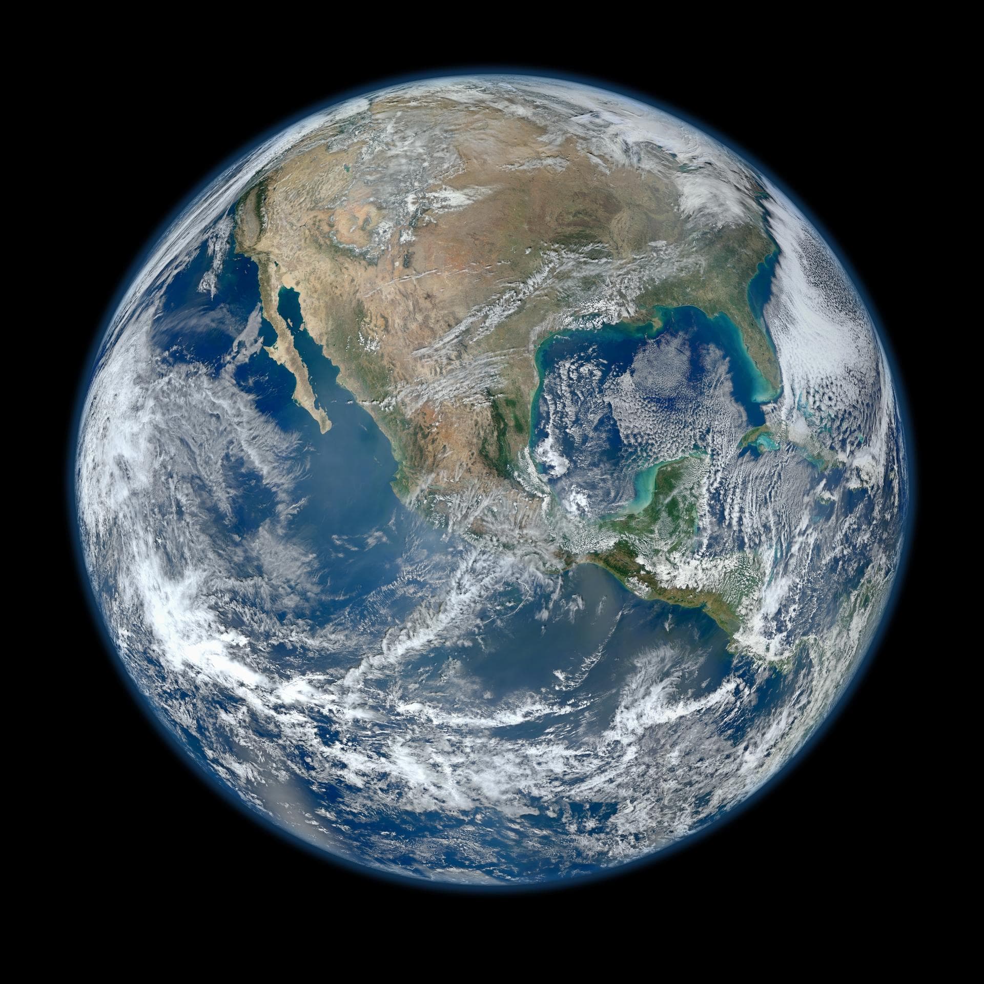A full-disk Blue Marble view of Earth showing the Americas, blue ocean and white cloud systems.
